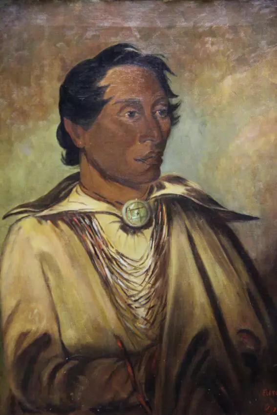 Painted portrait of a chief, hair appears to be windblown, he wears several necklaces and gazes off to the side.