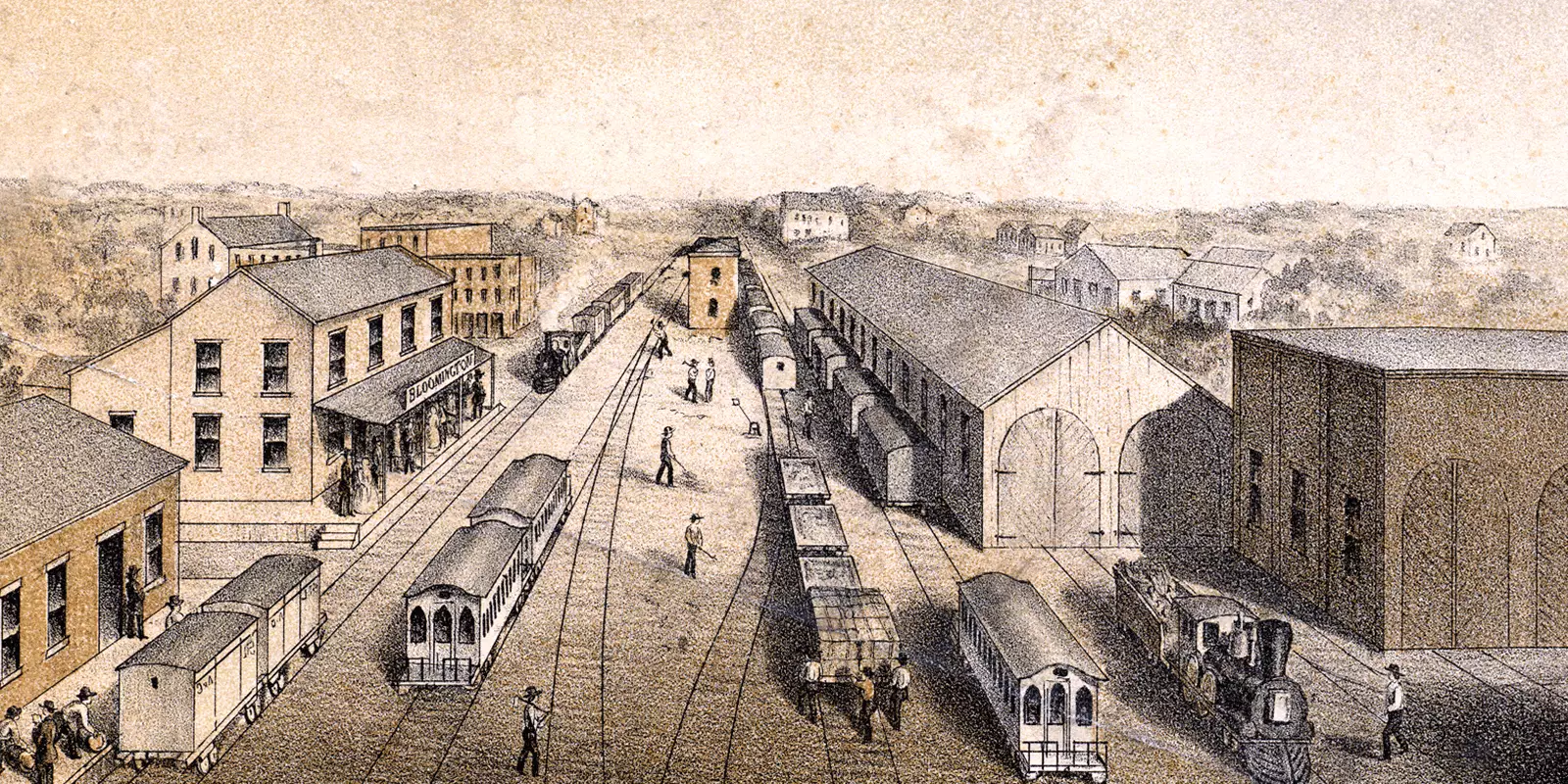 Railroad depot with six or seven railroads, showing a town on the left, and cars on the tracks while people walk around.