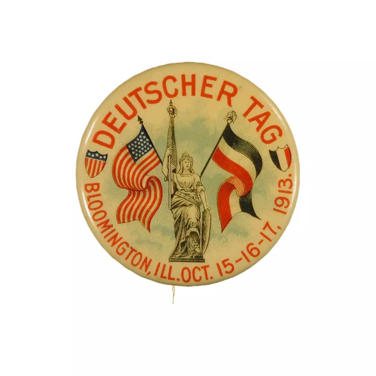 Pin with american and german flag. Text says DEUTSCHER TAG and Bloomington IL Oct 15-16-17, 1913.