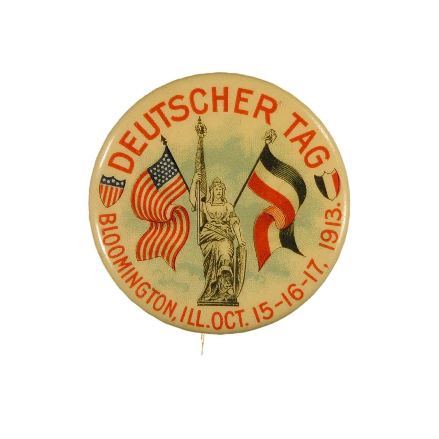 Pin with american and german flag. Text says DEUTSCHER TAG and Bloomington IL Oct 15-16-17, 1913.