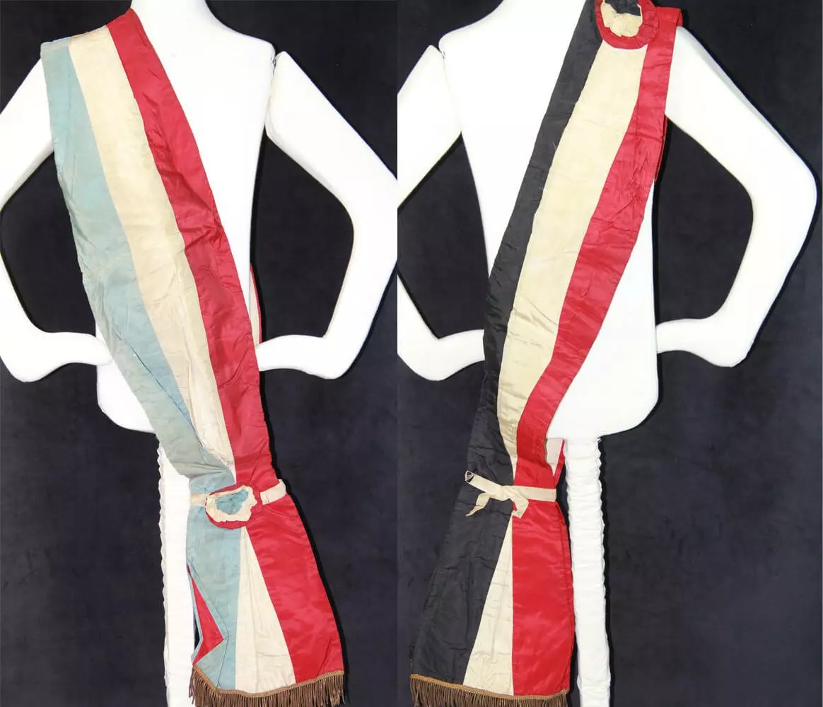 Left sash is blue, white, red. Right sash is black, white, red.