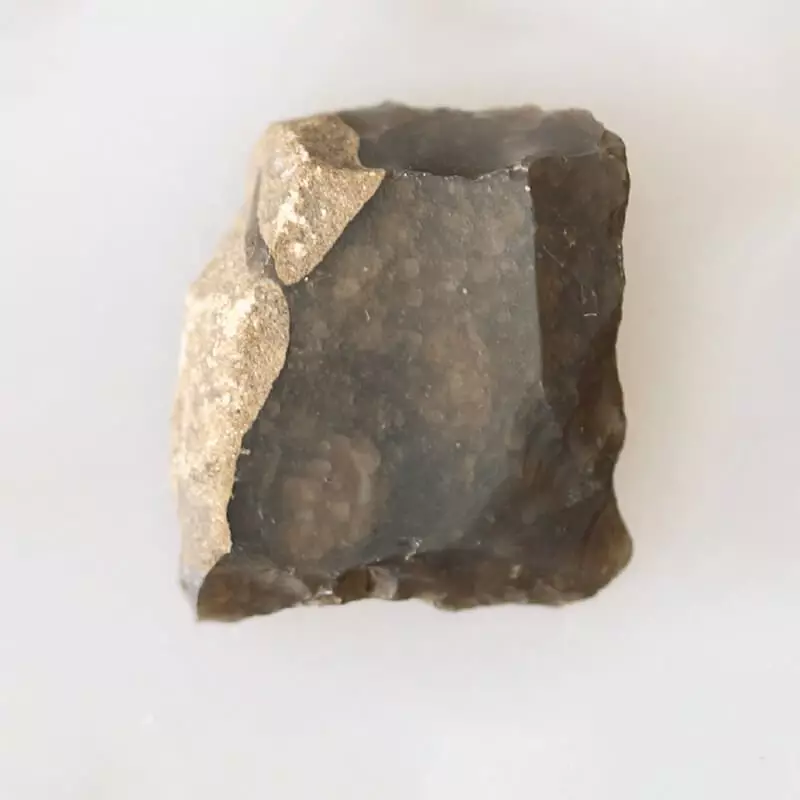 small sharp flint in hexagonal shape with smooth top surface