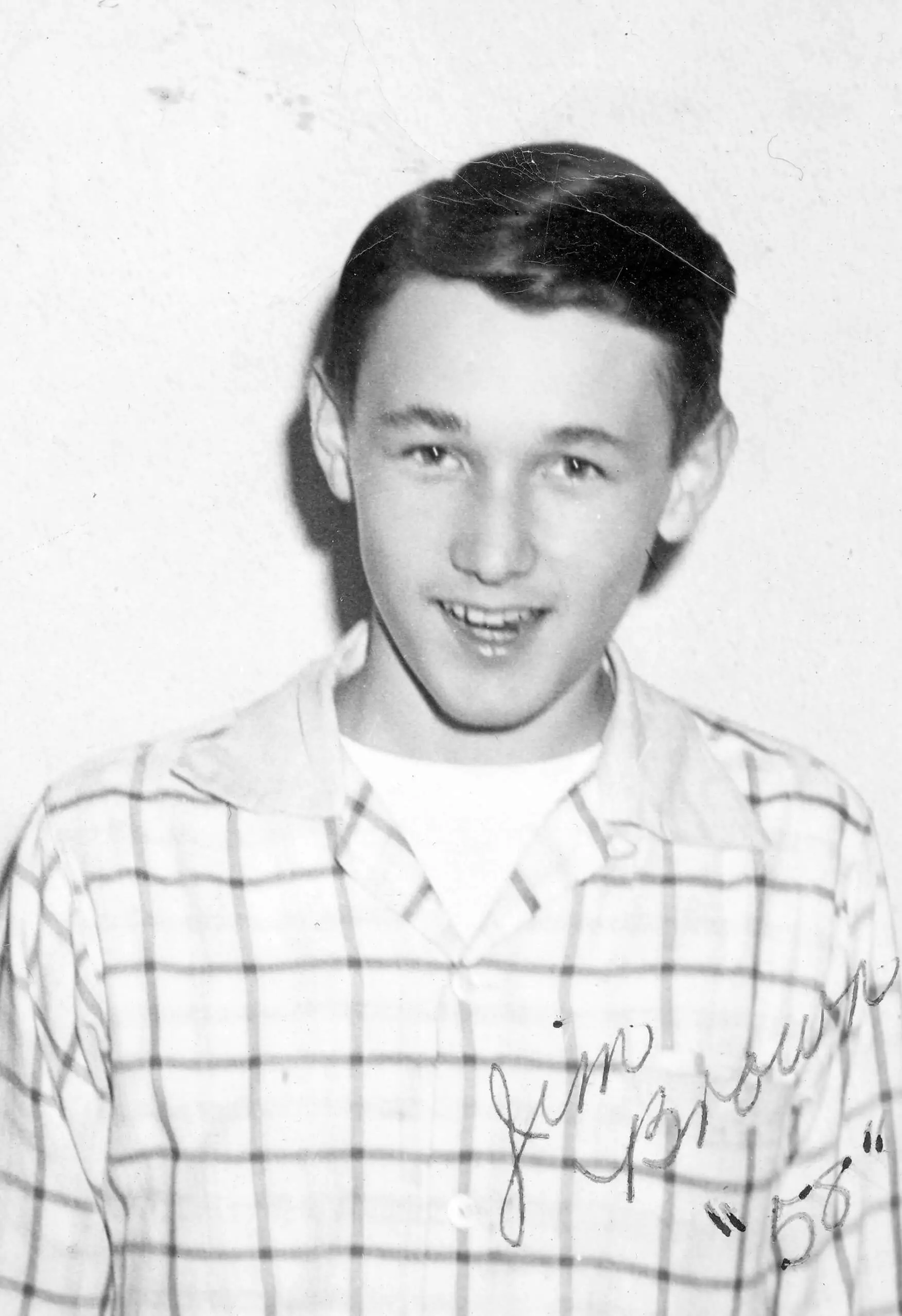 Portrait of Jim Brown, a smilng young white man wearing a a plaid shirt.