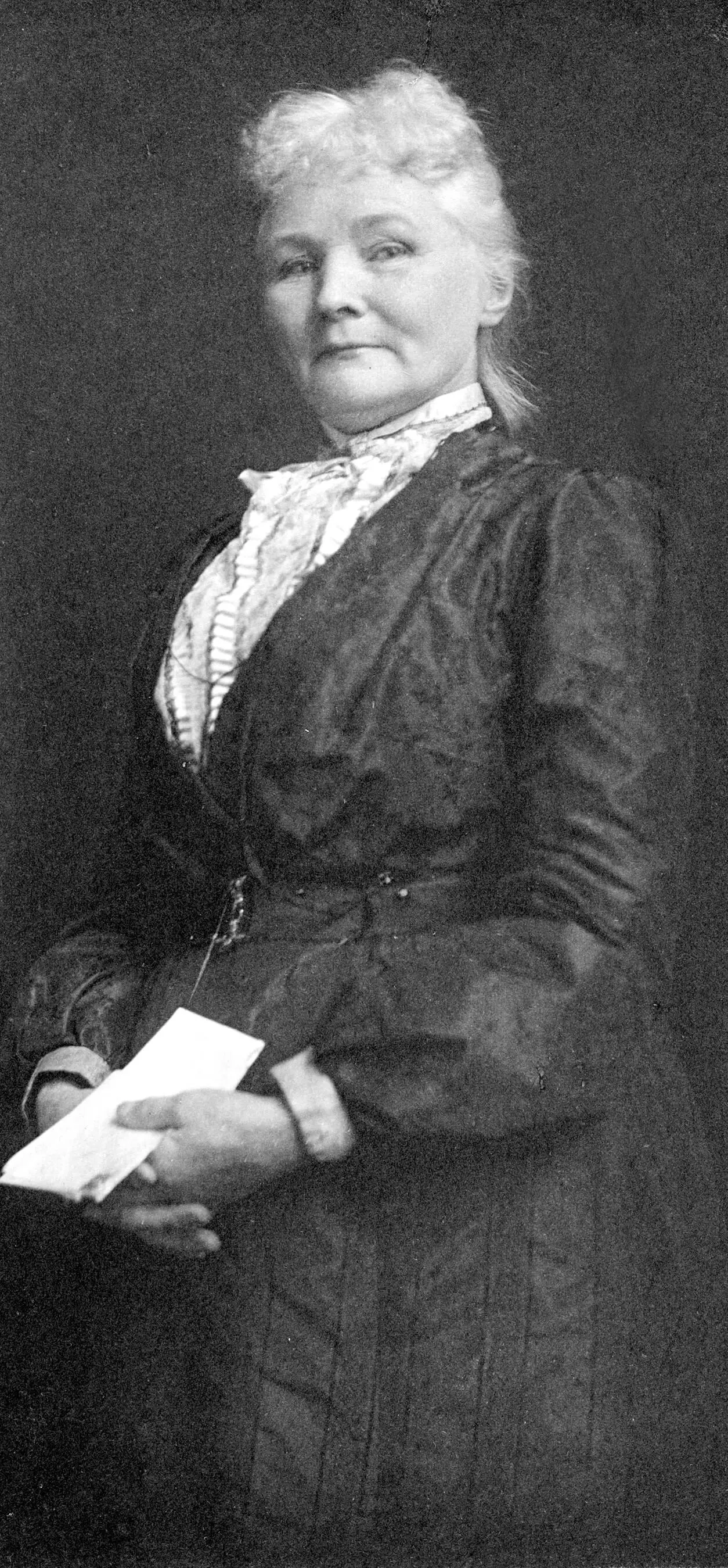 Black and white portrait of a white woman in a dress with white hair