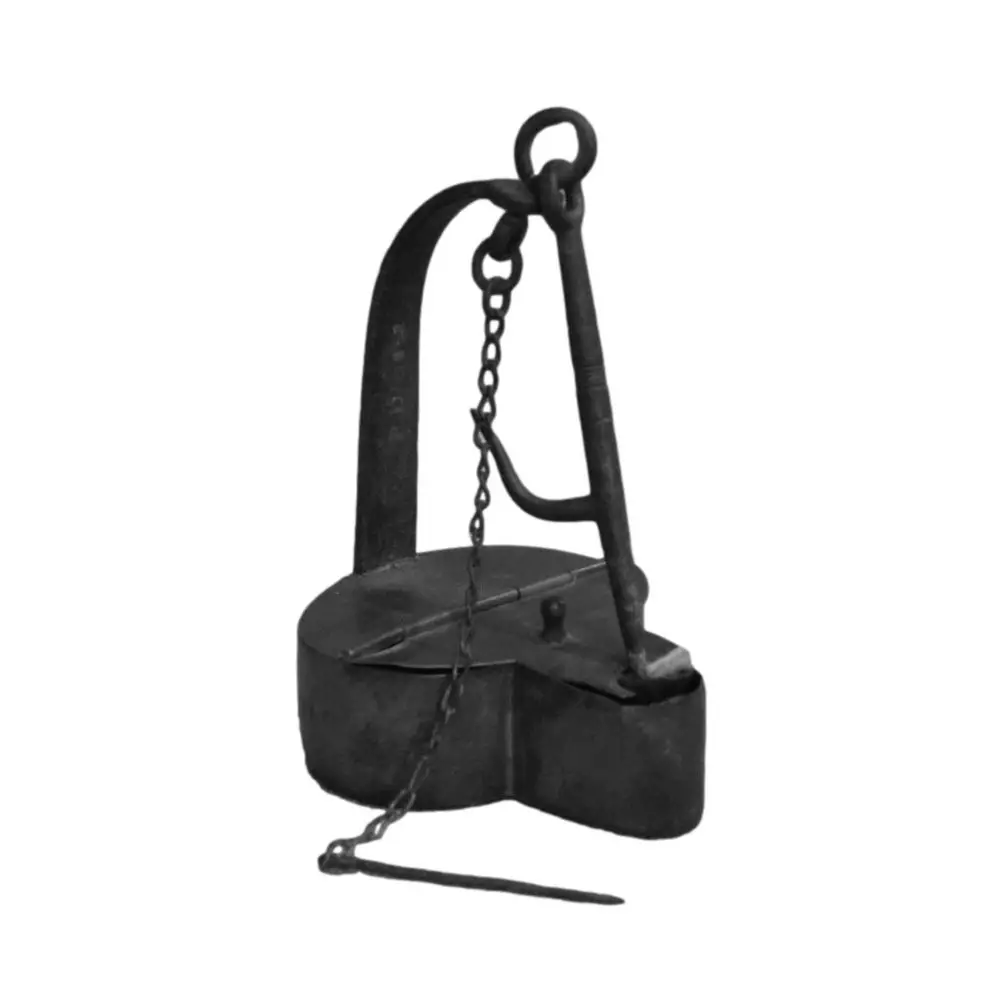 Photo of a large black iron container hanging from a large arched handle and chain. The top of the container has a hinge on it.