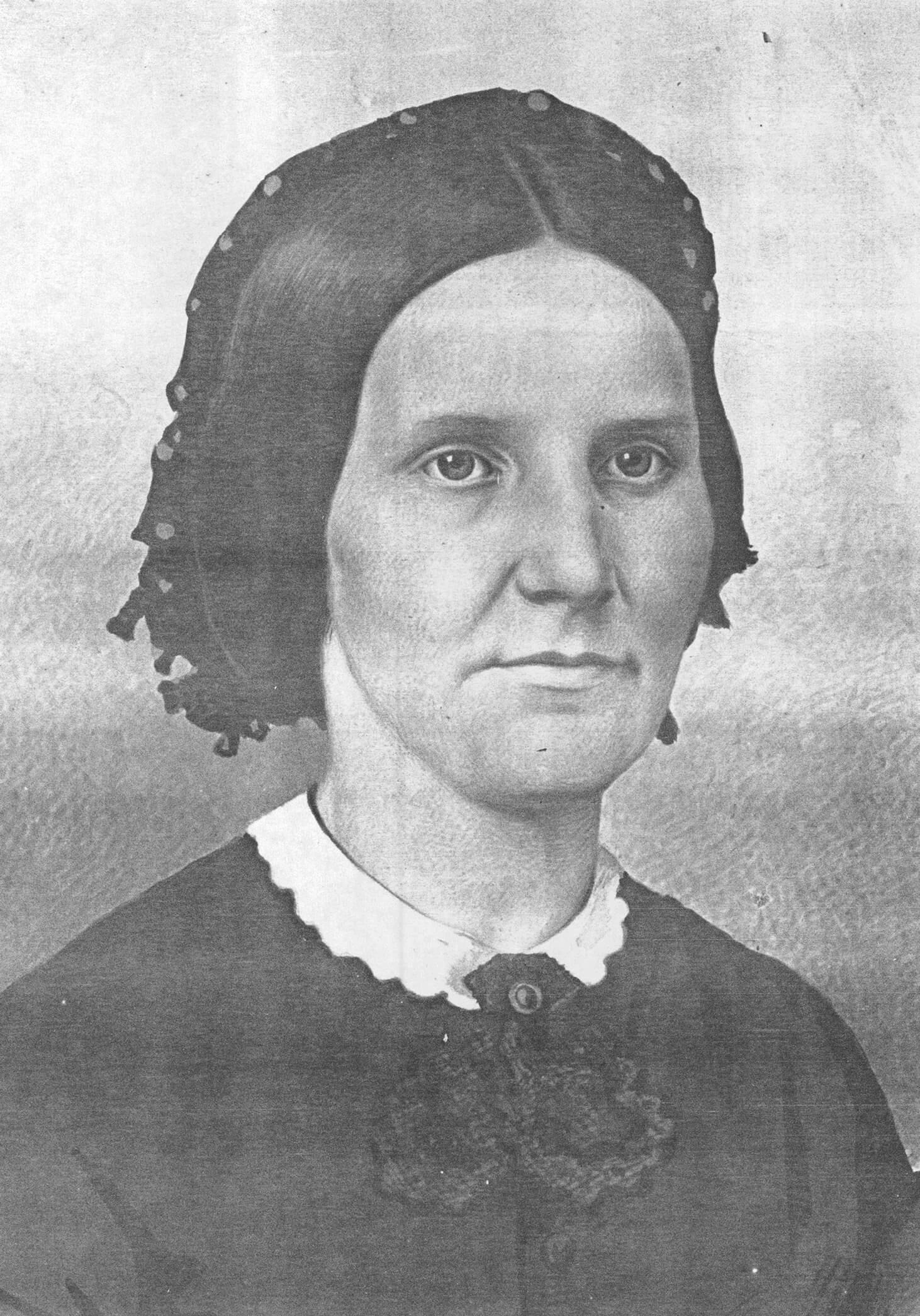 Black and white photo of a middle-aged woman wearing a black dress.