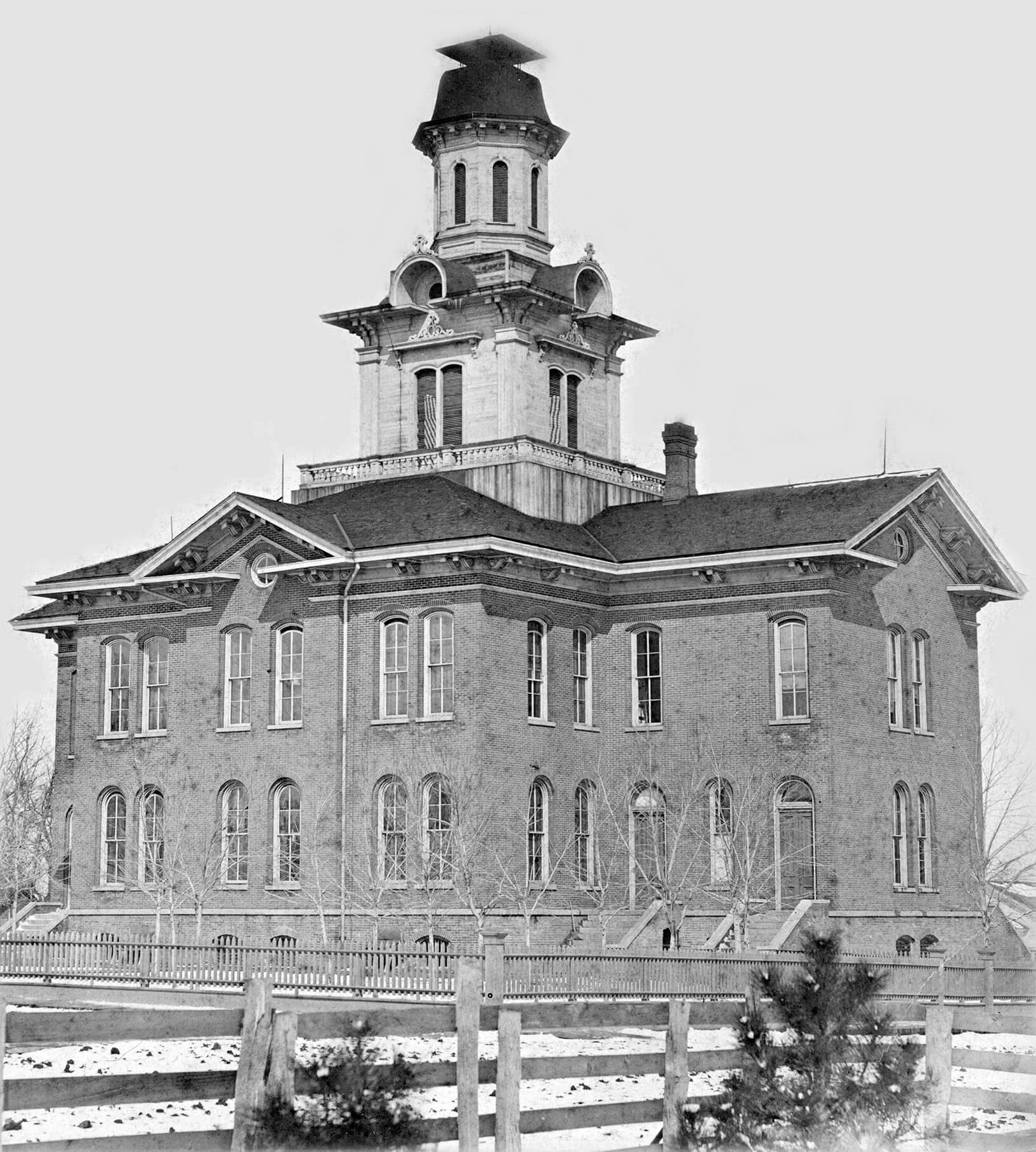 Three story brick school building, with large cupola