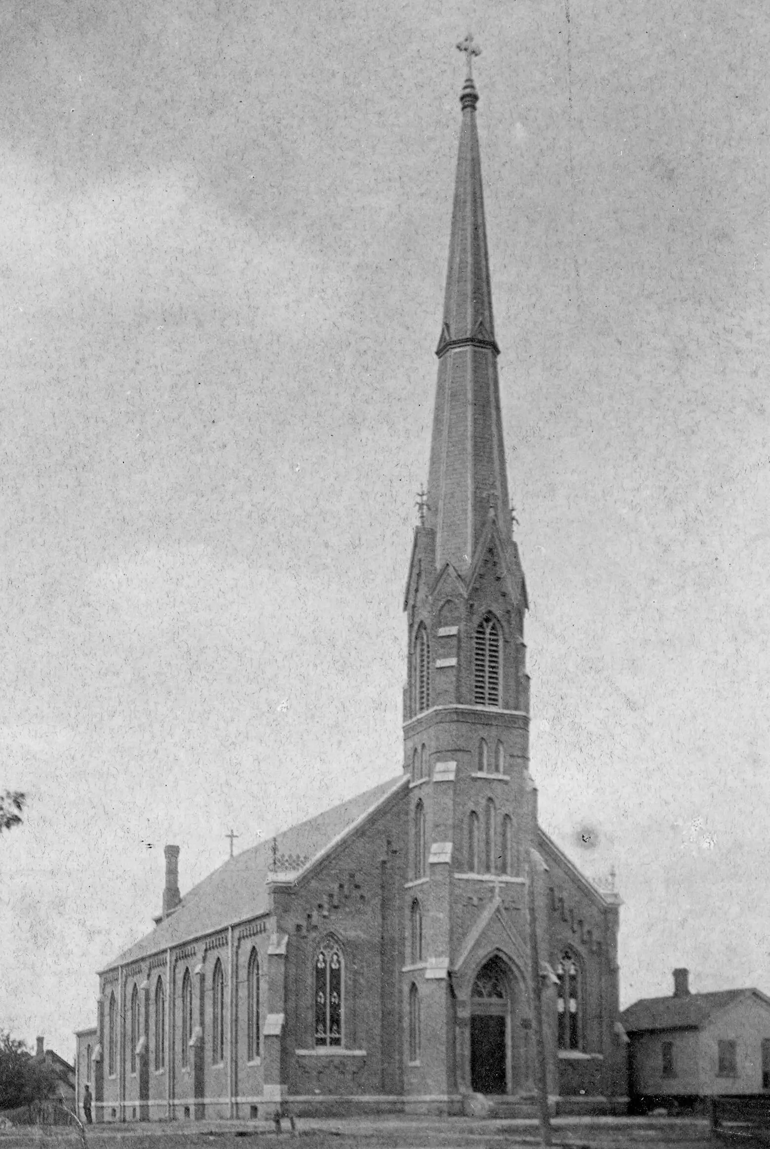 Large brick church with massive pointy steeple.