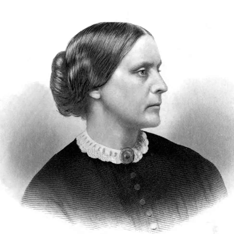 Black and white profile portrait of Susan B. Anthony, a white woman. She is wearing a dress with a lace collar and brooch at the neck.  Her hair is pulled into a bun. She has a serious look and is looking to her left.
