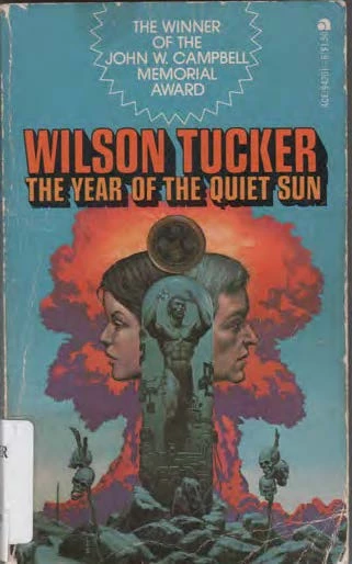 Book cover is mostly blue but a mushroom cloud is red and purple in the center. In front of the mushroom cloud are two profiles of faces, one facing the left and the other facing the right. In the center is a mostly naked chiseled male figure. In the foreground there is rubble and human skuls stacked on poles.